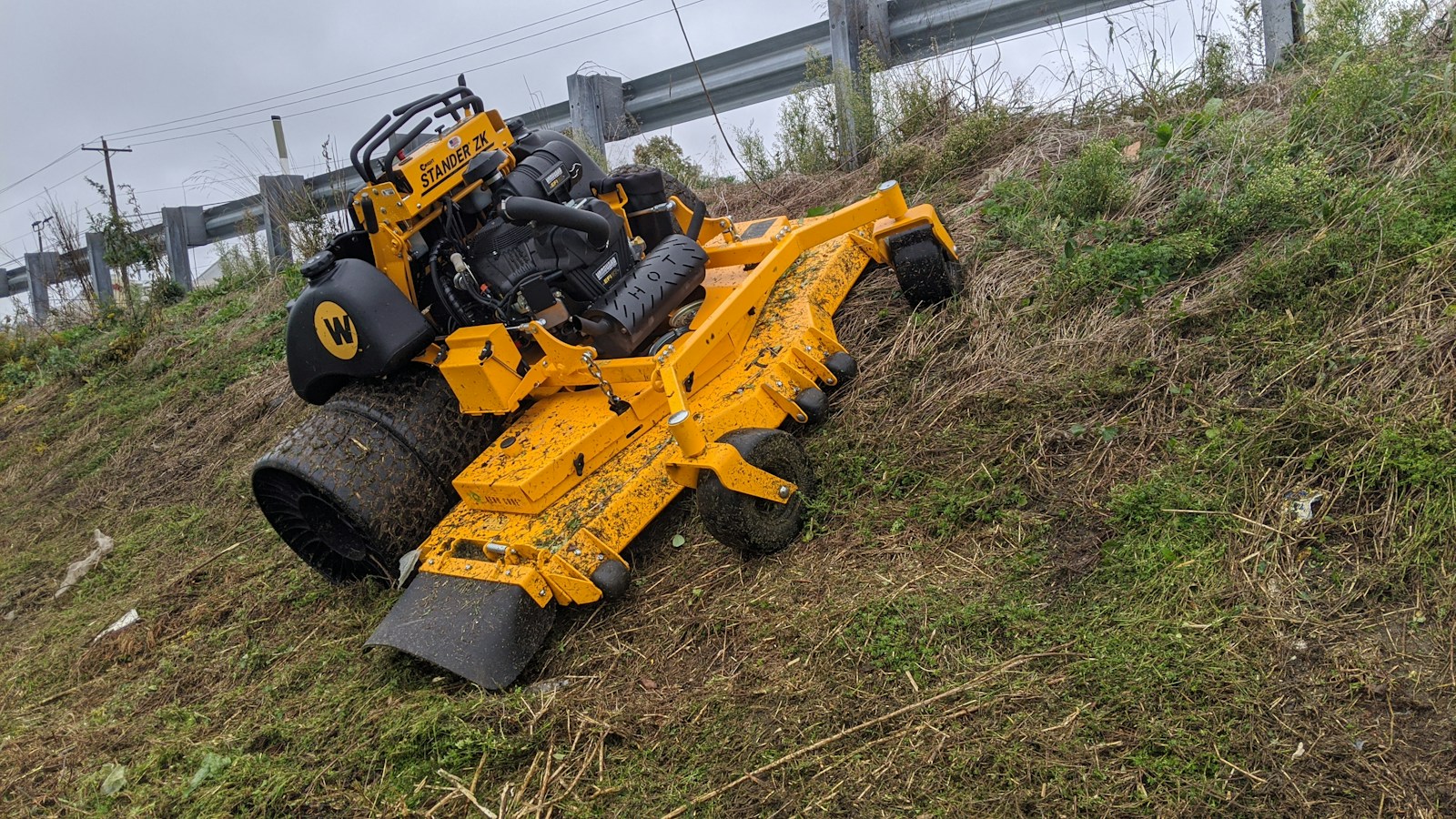 Commercial mowing equipment clearing a grass bank
