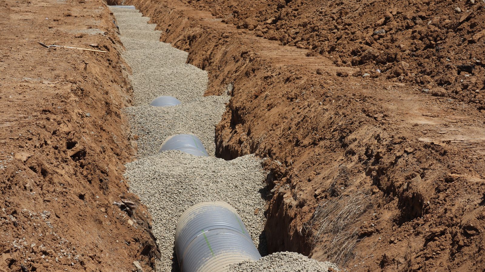 Drainage pipework laid in a gravel-lined trench